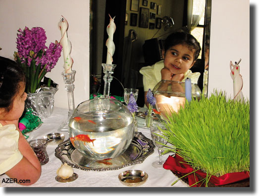 Inara Abernathy delighting in the typical Novruz table as prepared by Azerbaijanis from Iran which includes live goldfish, a mirror, "sabzi" (sprouted grain). In Bell Buckle, Tennessee  Abernathy family