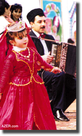  Young child in traditional costume dancing to garmon accompaniment.  Jeff Cornish