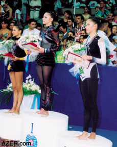 (Left) Azerbaijani Dinara Gimatova competes in the World Cup Rhythmic Gymnastics that were held in Baku in August. She took Third Place. Right: World Cup Rhythmic Gymnastics (2nd stage for 2003): 1st place: Alina Kabayeva, Russia; 2nd place: Irina Chashina, Russia; 3rd place (far right) Dinara Gimatova, Azerbaijan.