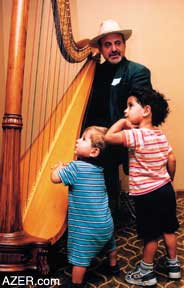 Harpist Michael O'Shiver captivates some of the children during dinner the first evening of the reunion.
