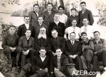 Ahmad with other prisoners at Kolyma prison camp in Siberia, 1956. It seems that prisoners dressed up for formal photos. Ahmad is seated on the first row, second from right, with his arm on his knee. This was the year that Ahmad was released following. Hundreds of thousands of prisoners were released that year - three years after Stalin's death.