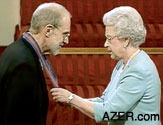 Her Majesty Queen Elizabeth II bestowing the Order of St Michael and St George upon David Woodward. 